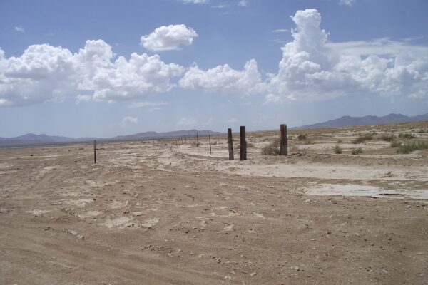 Wide, flat dry lakebed of the Willcox Playa under a cloudy sky in Cochise County, Arizona