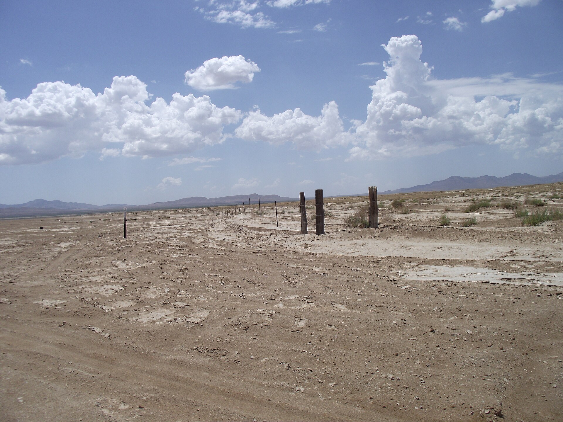 Wide, flat dry lakebed of the Willcox Playa under a cloudy sky in Cochise County, Arizona