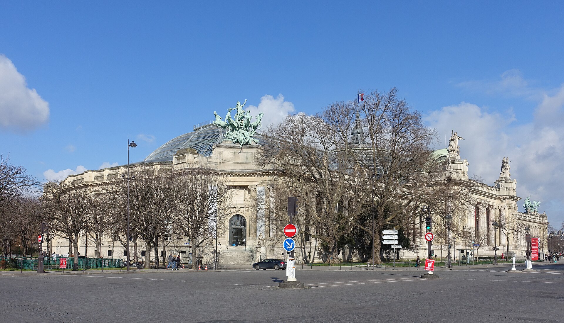 Exterior of the Grand Palais in Paris with its glass roof, columns and bronze sculpture