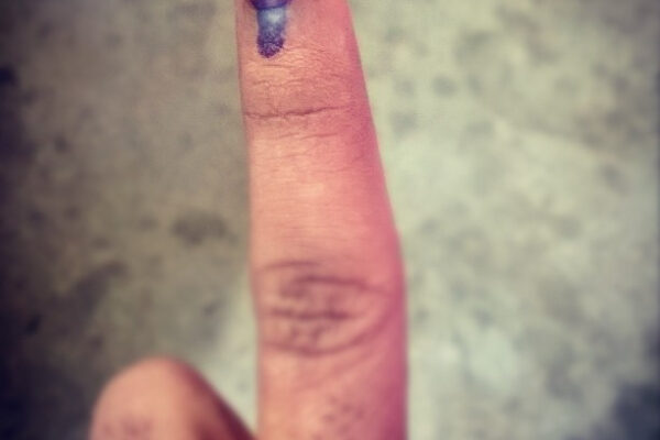 An inked finger after voting in India