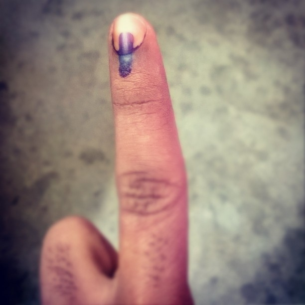 An inked finger after voting in India