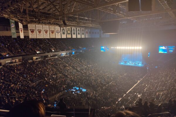 Jimmy Eat World performing on a lit stage in a packed arena