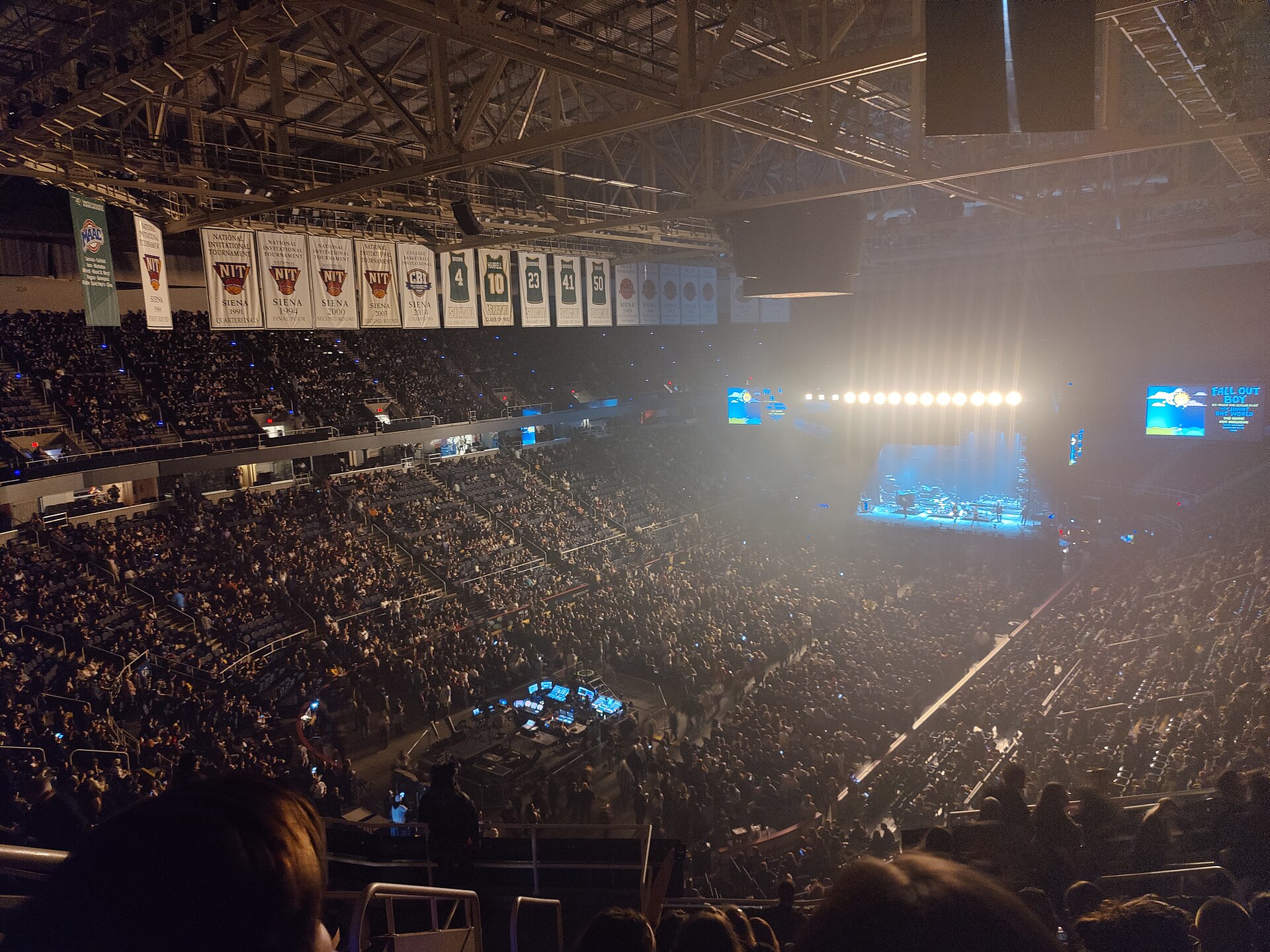 Jimmy Eat World performing on a lit stage in a packed arena