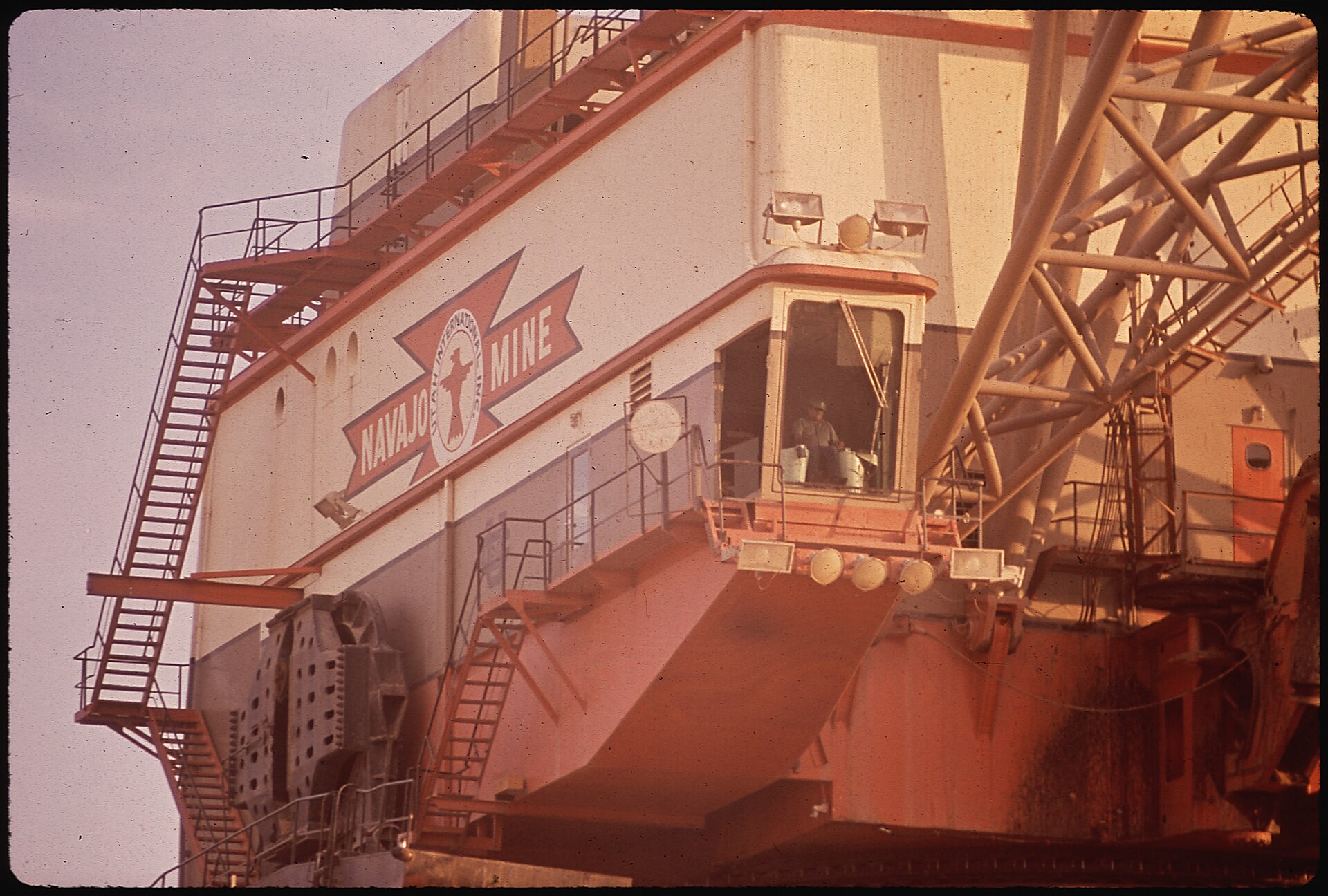 Large industrial dragline machine with stairs and cab at the Navajo coal mine, 1972