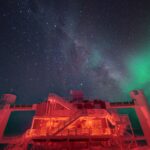 IceCube Laboratory building at the South Pole under a starry night sky