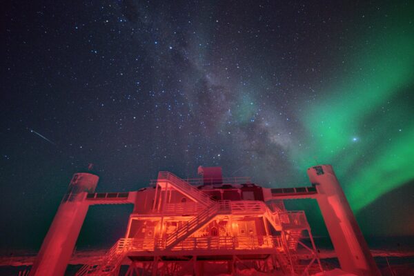 IceCube Laboratory building at the South Pole under a starry night sky