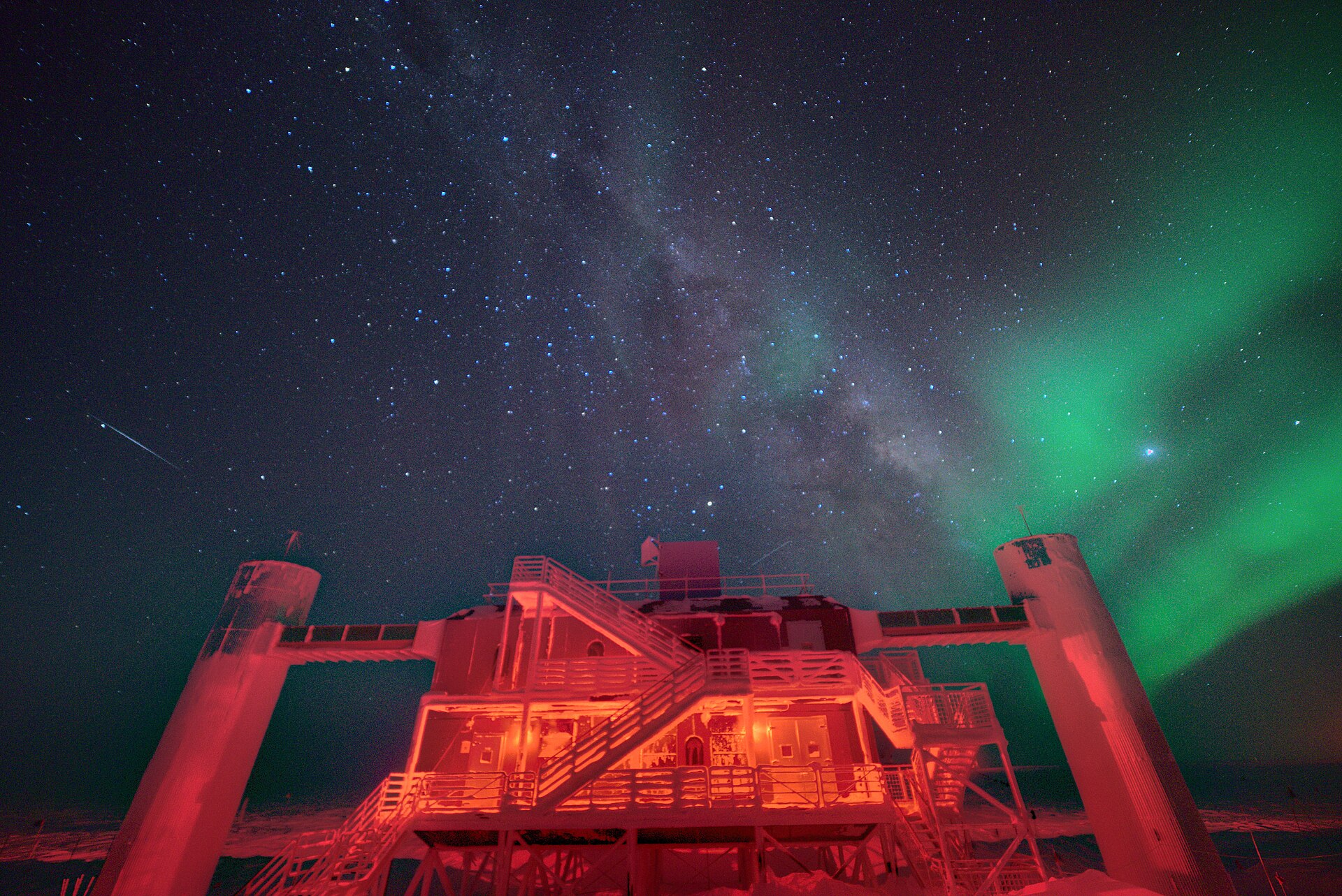 IceCube Laboratory building at the South Pole under a starry night sky