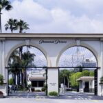 Ornate arched entrance gate of Paramount Pictures studios with palm trees