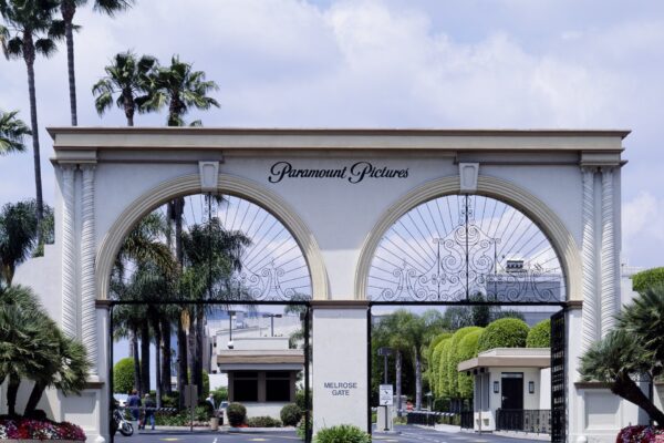 Ornate arched entrance gate of Paramount Pictures studios with palm trees