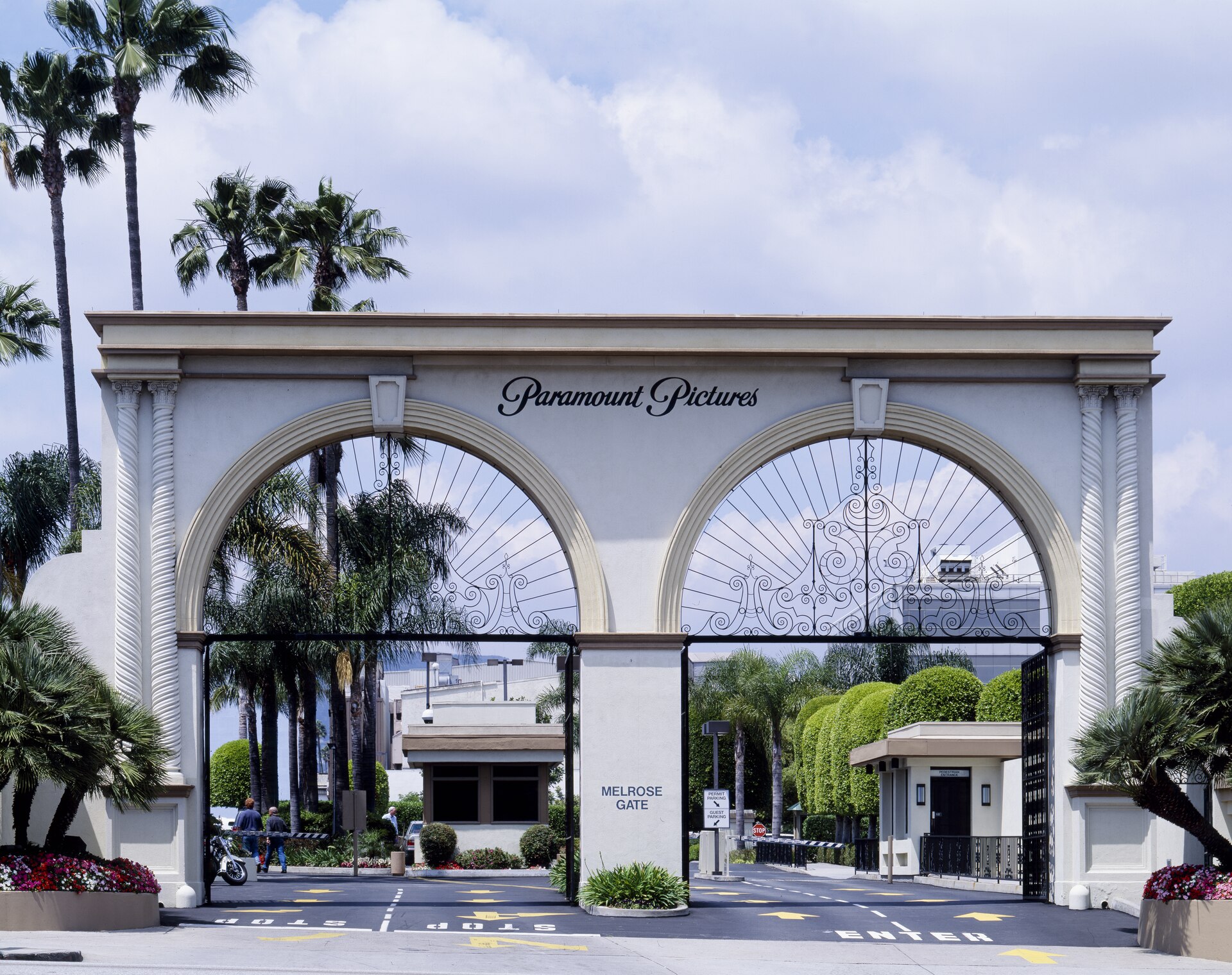 Ornate arched entrance gate of Paramount Pictures studios with palm trees