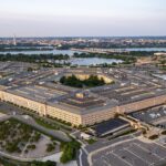 Aerial photograph of the five-sided Pentagon building and surrounding parking lots