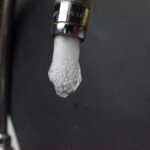 Water running from a kitchen faucet