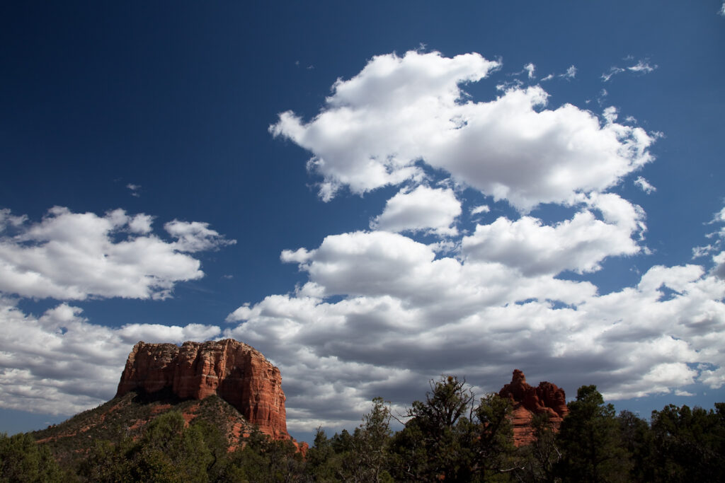 Red sandstone buttes under a blue sky with white clouds in Sedona, Arizona
