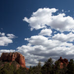 Red sandstone buttes under a blue sky with white clouds in Sedona, Arizona