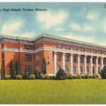 Vintage color postcard of a large red-brick, columned high school building in Tucson